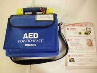 AEDと書かれた青色バックが壁にかけられている写真